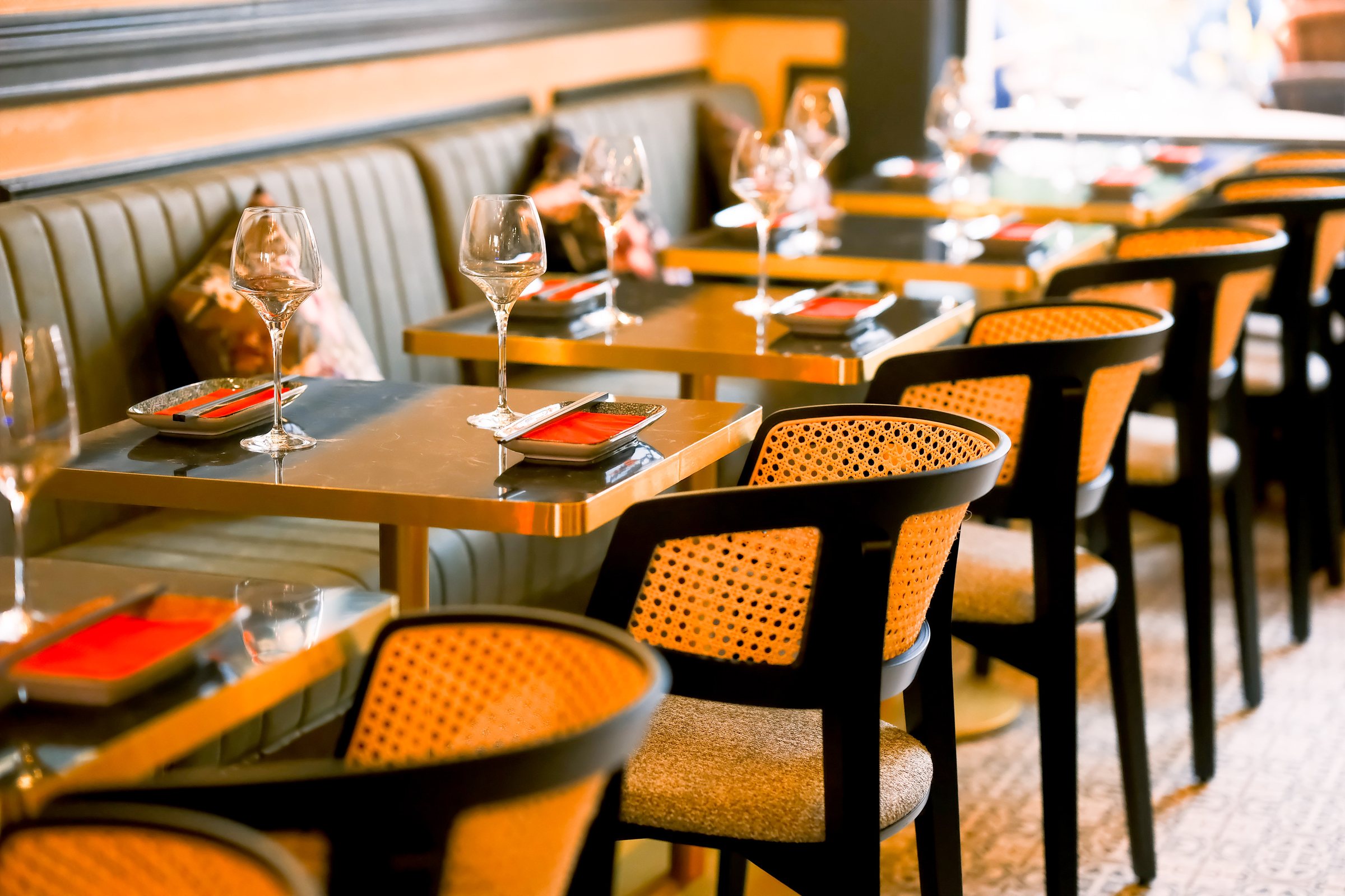 Tables set along the banquette in the dining room