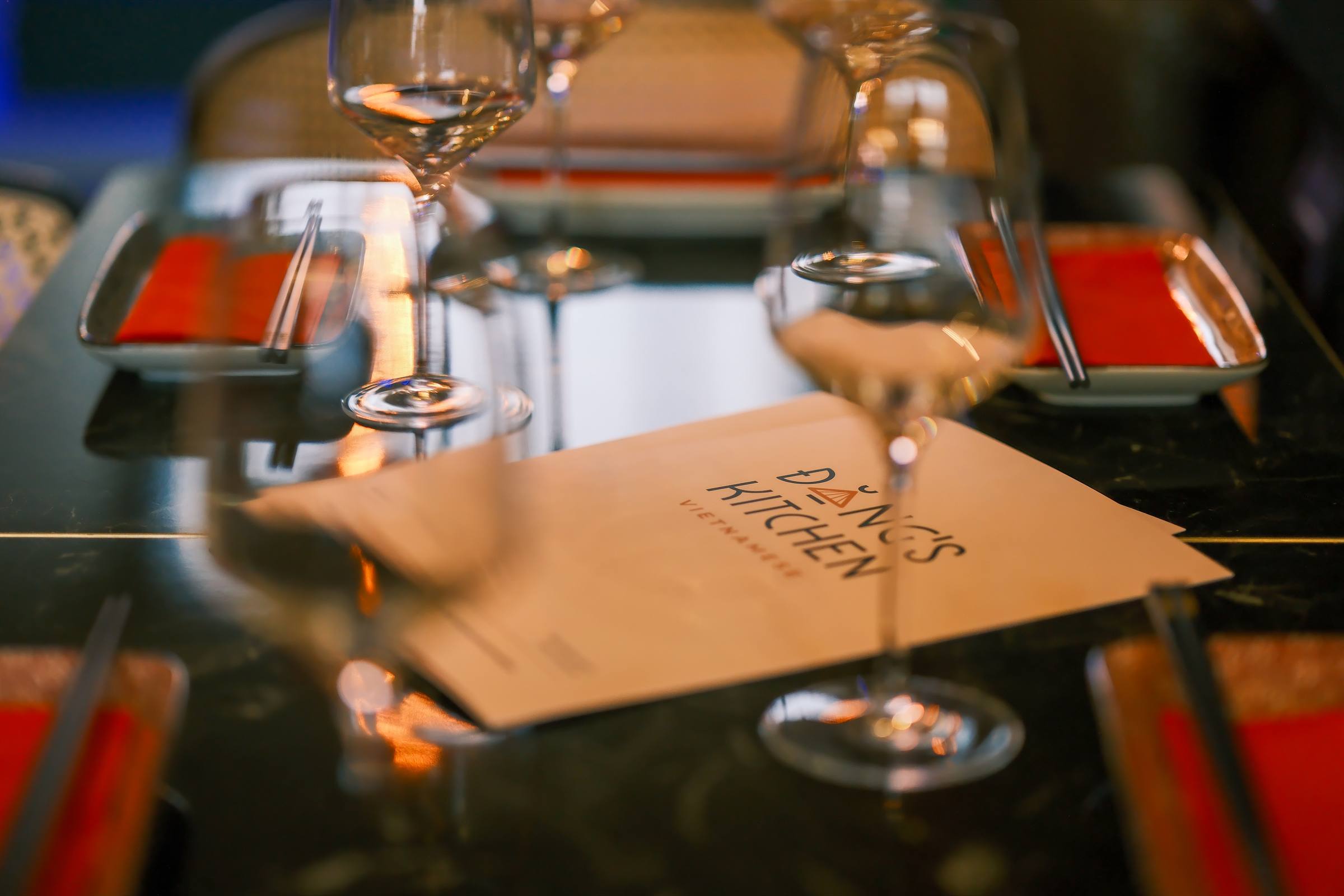 A table set with wine glasses and chopsticks